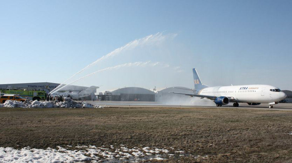 Wichita Fire Department and Mid-Continent employees give departing Wichita State University charter jet a water cannon salute. Courtesy Mid-Continent Airport.