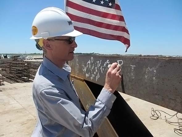 Philip Hannon signs the steel beam