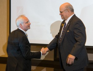 Rolland Vincent shakes hands with Wichita Aero Club President Dave Franson as he steps up to the stage. Photo: Darin LaCrone