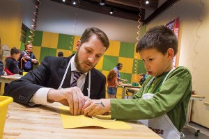 Jason Cox, chief technical officer at Cox Machine and vice chairman of the board at Sedgwick County's Exploration Place, works on a circuitry project with Jackson McKibban in Exploration Place's new CreatorSpace. Photo by Kellen Jenkins/WBJ.