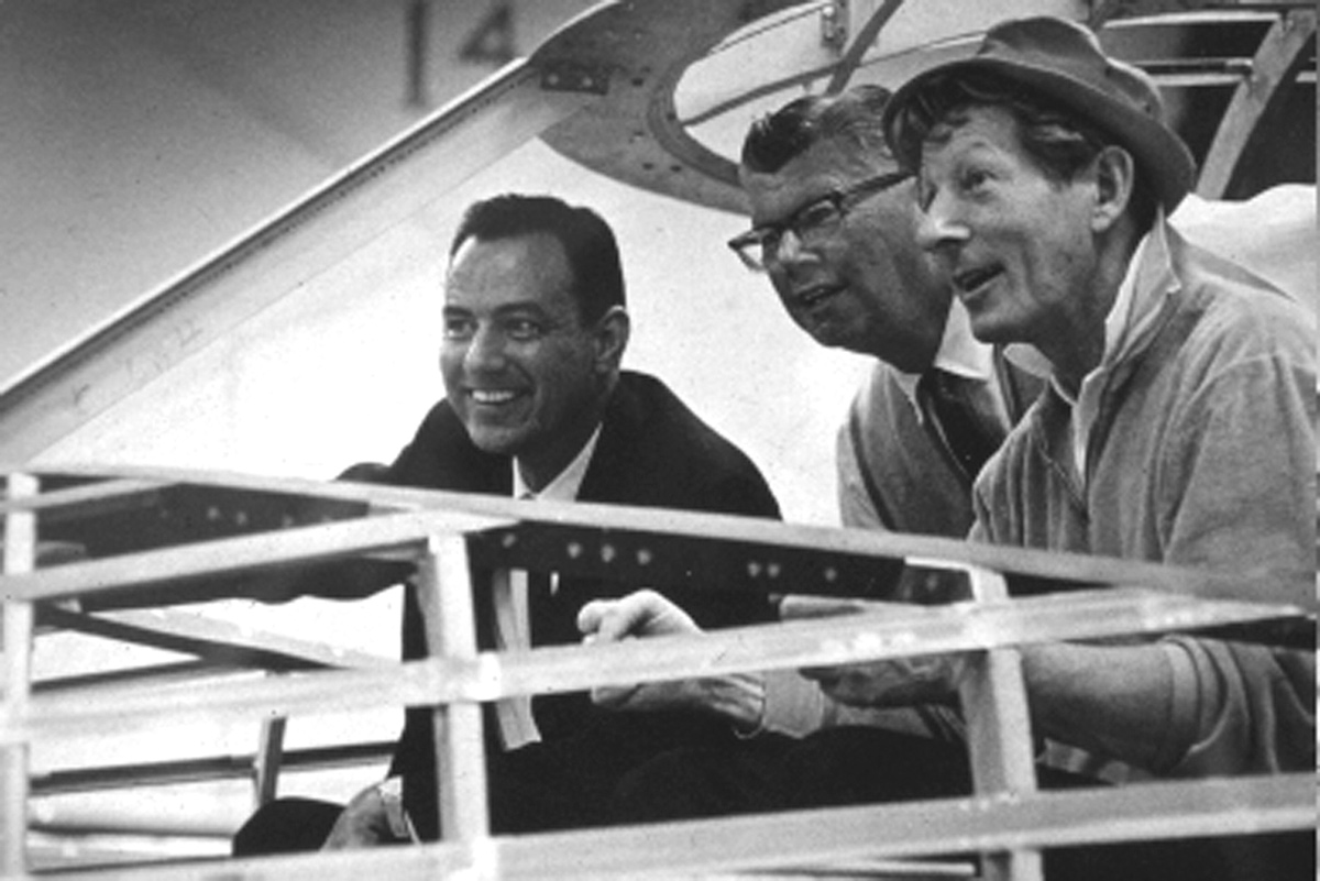 Panel moderator Paul Bowen cautioned the room full of aviation enthusiasts to just get up and leave when they needed to, saying, “Trust me, Clay won’t run out of stories.” In this vintage photo, Lacy’s pictured with Bill Lear and actor Danny Kaye.